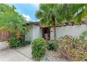 Front entrance featuring mature tropical landscaping and a well-maintained walkway at 4644 Red Maple Rd # 1303, Bradenton, FL 34210