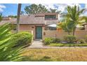 Inviting townhouse exterior featuring a private courtyard, desert landscaping, and unique architecture at 5273 Myrtle Wood # 37, Sarasota, FL 34235