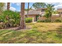 Inviting townhouse with lush landscaping, mature trees, and private courtyard entrance at 5273 Myrtle Wood # 37, Sarasota, FL 34235