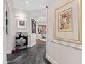Stylish entryway features elegant decor, modern artwork, and sleek black marble flooring at 5531 Cannes Cir # 201, Sarasota, FL 34231