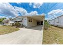 Attractive single-story home with a covered carport and a well-kept lawn at 5619 Bayshore Rd # 164, Palmetto, FL 34221