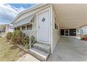Welcoming single-story home with a covered parking area and manicured flower bed at 5619 Bayshore Rd # 164, Palmetto, FL 34221