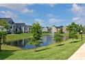 Scenic community view featuring a tranquil pond and manicured green spaces at 5681 Bidwell Pkwy # 102, Sarasota, FL 34233