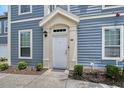 Welcoming entryway featuring a covered porch and meticulous landscaping at 5681 Bidwell Pkwy # 102, Sarasota, FL 34233