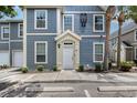 Charming condo featuring a covered entryway and well-maintained landscaping at 5681 Bidwell Pkwy # 102, Sarasota, FL 34233