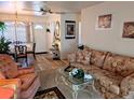 A cozy living room with floral sofa and chairs with dining room and front door views at 5895 17Th W St # B-26, Bradenton, FL 34207