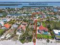 This aerial view shows deeded beach access to the beautiful white sands of Anna Maria Island at 5924 Gulf Of Mexico Dr, Longboat Key, FL 34228