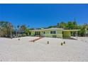 Charming single story home with a covered carport and mature landscaping at 5924 Gulf Of Mexico Dr, Longboat Key, FL 34228