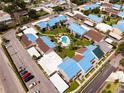 An aerial view of condos with blue roofs surrounding a central pool and green space at 5964 7Th W Ave # 5964, Bradenton, FL 34209