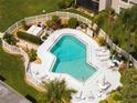 Aerial shot of a community pool area with lounge chairs, tables, and manicured landscaping at 5964 7Th W Ave # 5964, Bradenton, FL 34209