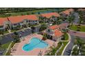 Community aerial view showcasing a sparkling swimming pool and lush landscaping at 6151 Bahia Del Mar Blvd # 123, St Petersburg, FL 33715