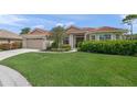 Inviting single-story home showcases a tile roof, mature landscaping, and an attached two-car garage at 6664 Deering Cir, Sarasota, FL 34240