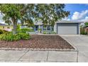 Charming single-story home with attached two-car garage, tidy landscaping, and covered front entryway at 7719 9Th Avenue Nw Dr, Bradenton, FL 34209