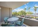 Cozy balcony area with seating and views of the waterway and marina at 1400 1St W Ave # 203, Bradenton, FL 34205