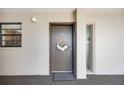 Inviting entryway with a decorated front door and sidelight windows at 1400 1St W Ave # 203, Bradenton, FL 34205