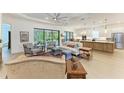Open-concept living room with hardwood floors, lots of natural light, and access to the kitchen at 15605 Derna Ter, Bradenton, FL 34211