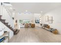 Spacious living room with high ceilings, light wood floors, modern decor and large windows with lake views at 18215 Cayo Largo Pl, Bradenton, FL 34202