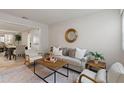 Cozy living room with neutral tones, wood accents, a decorative mirror, and lots of natural light at 2507 Beneva Rd # 2, Sarasota, FL 34232