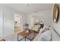 This cozy living room leads to the kitchen and dining room and is flooded with natural light at 2507 Beneva Rd # 2, Sarasota, FL 34232