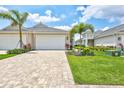 Gorgeous exterior view of a home boasting a large driveway and lush, tropical landscaping at 251 Okeeffe Cir, Bradenton, FL 34212