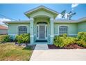 Inviting front entrance with well-manicured landscaping and a screened front door at 2759 Starview Ave, North Port, FL 34288