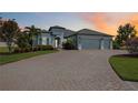 Beautiful single-story home featuring a spacious driveway, a three-car garage, and manicured landscaping at 308 Chantilly Trl, Bradenton, FL 34212