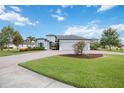 Charming single-story home featuring a three-car garage, lush landscaping, and a well-manicured front lawn at 308 Chantilly Trl, Bradenton, FL 34212
