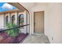 Inviting front porch area with neutral-colored door and attractive tile flooring at 3510 Shawn St, Punta Gorda, FL 33980