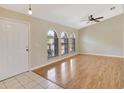 Bright living room features wood floors, vaulted ceiling, and arch windows at 3510 Shawn St, Punta Gorda, FL 33980