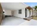 Attached carport offering convenient covered parking and access to the home's entrance and side yard at 3616 Stardust Pl, Sarasota, FL 34232