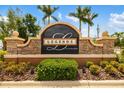 Elegant Legends at Tatum Ridge stone community entrance sign with manicured landscaping and palm trees at 370 Londonderry Dr, Sarasota, FL 34240