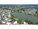 Aerial view of the property nestled on a lake with lush surroundings in a serene neighborhood at 415 Courbet Dr # 415, Nokomis, FL 34275
