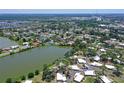 Scenic aerial view of the property with a lake backdrop and the expansive neighborhood beyond at 415 Courbet Dr # 415, Nokomis, FL 34275