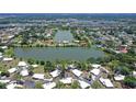 Wide aerial view showcasing the property's lakeside location and the surrounding neighborhood at 415 Courbet Dr # 415, Nokomis, FL 34275