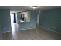 Open-concept living area with tile floors, white cabinets, and lots of natural light at 4304 78Th W St # 4304, Bradenton, FL 34209