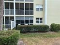 Exterior view of the condo building with a screen enclosed patio and greenery at 433 Cerromar Ln # 331, Venice, FL 34293