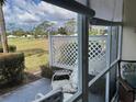 Screened-in patio with seating area overlooking lush greenery and golf course at 433 Cerromar Ln # 331, Venice, FL 34293