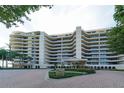 Beautiful condominium with balconies and a circular driveway enhanced by lush landscaping and palm trees at 435 L Ambiance Dr # K506, Longboat Key, FL 34228
