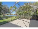 Screened lanai with views of the lake and lush greenery, perfect for relaxing and entertaining at 4978 Cedar Oak Way, Sarasota, FL 34233