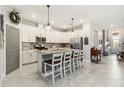 Bright kitchen featuring white cabinets, stainless steel appliances, and a spacious island with seating at 5165 Coral Reef Way, Bradenton, FL 34211