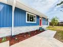 The exterior of this charming blue home features a well-manicured lawn and attractive landscaping at 5307 47Th Street E Ct, Bradenton, FL 34203