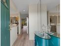 Bright entryway with a modern console table and mirror, leading into the kitchen and living area at 5632 Ashton Lake Dr # 5632, Sarasota, FL 34231