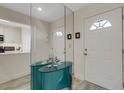 Hallway featuring a mirrored console, with views of the front door and kitchen, creating an open feel at 5632 Ashton Lake Dr # 5632, Sarasota, FL 34231