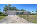 Street view of a single-story home with a long driveway and attached garage at 5706 10Th Avenue Dr W, Bradenton, FL 34209