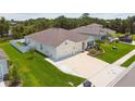 Aerial view of home featuring a well-manicured lawn, attached two-car garage, and colorful landscaping at 5904 114Th E Dr, Parrish, FL 34219