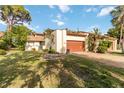Charming villa featuring a well-manicured lawn, gravel driveway, and a two-car garage at 6203 Courtside Dr # 21, Bradenton, FL 34210
