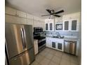 Well-lit kitchen with stainless steel appliances and white cabinets at 647 Woodlawn Dr # 647, Bradenton, FL 34210