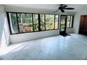 Enclosed sunroom with tile floors and windows overlooking garden at 647 Woodlawn Dr # 647, Bradenton, FL 34210