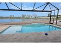 Beautiful screened pool overlooking a serene lake and neighboring homes at 650 Maldives Trl, Sarasota, FL 34234