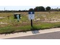 Vacant homesite ready for development, featuring a homesite marker and easy access to utilities at 659 Maldives Trl, Sarasota, FL 34234